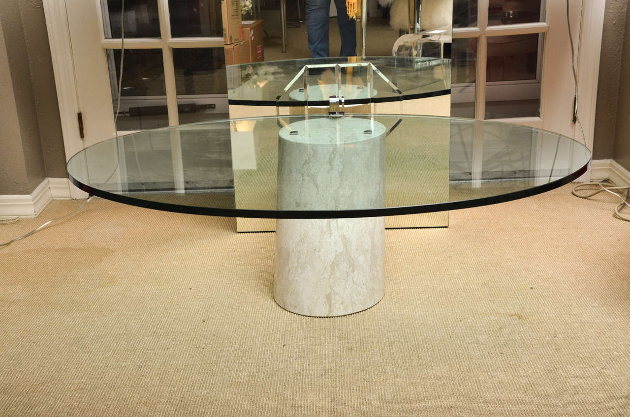 Vintage oval cantilevered cocktail table by Ronald Schmitt. The table has a marble base and oval glass top.